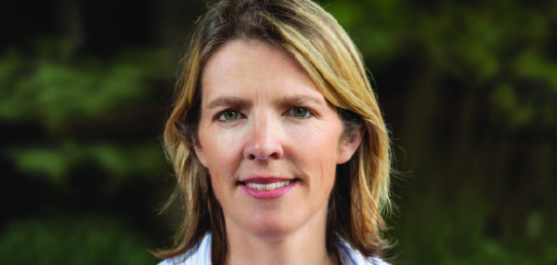 Photo of a woman wearing a pinstrip shirt.